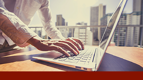 hr professional typing on a laptop computer in an office building