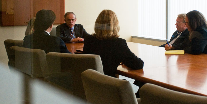 business leaders sitting around a table at a law firm