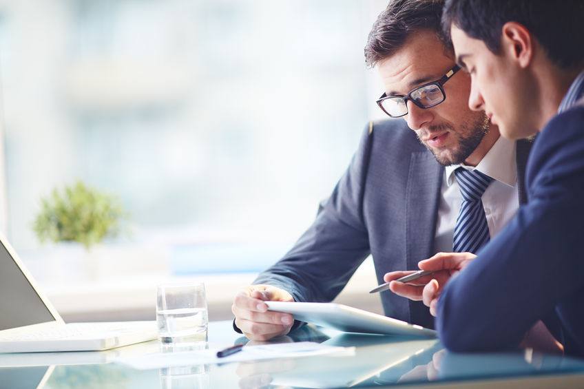 Young employee listening to his manager explain open enrollment options