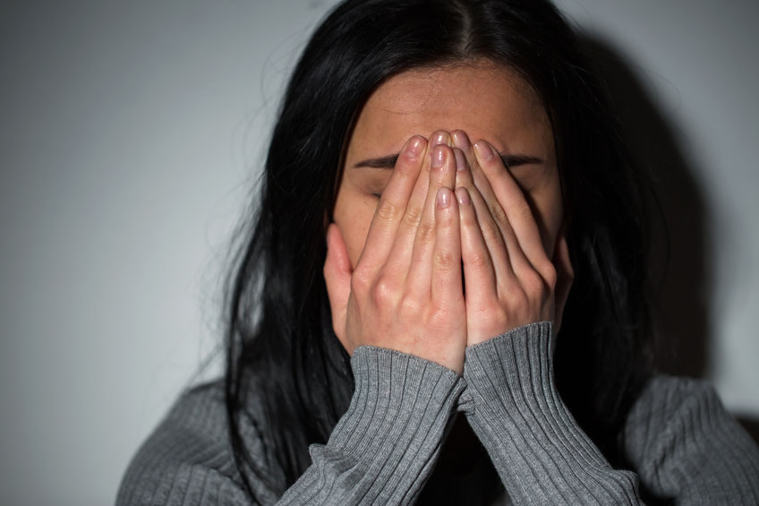 close up of unhappy crying woman due to sexual harassment in the workplace