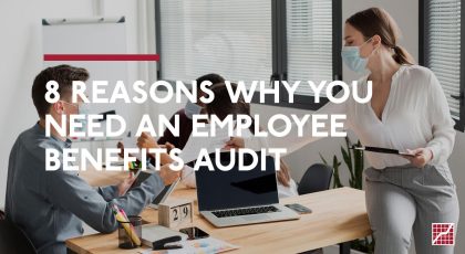 8 Reasons Why you Need An Employee Benefits Audit. Woman in office handing a document to an employee.