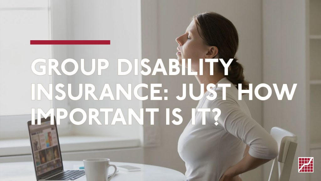 Group Disability Insurance - Woman Holding her Lower Back in a Brightly Lit Office