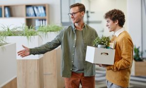 Smiling Mentor Welcoming Young Man at New Job