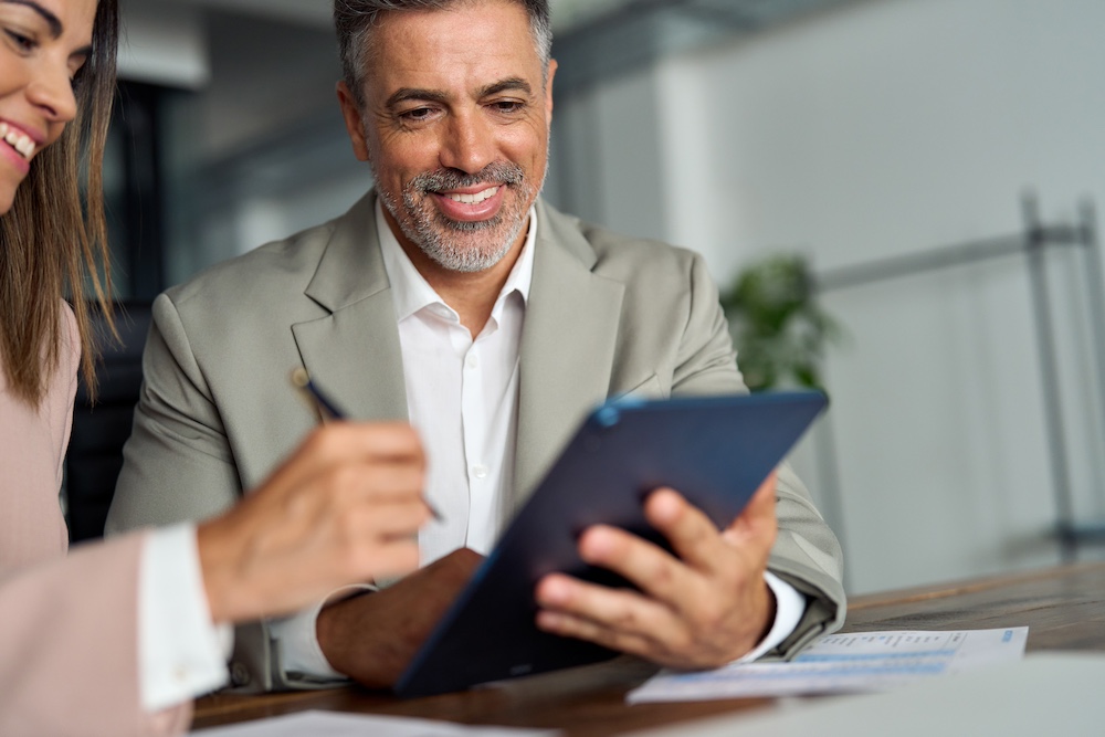 Older executive business man meeting bank manager consulting client with tablet.