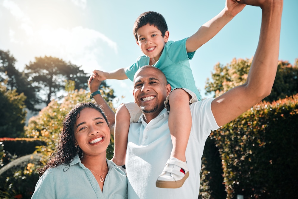 Mother, father and child portrait outdoor as family