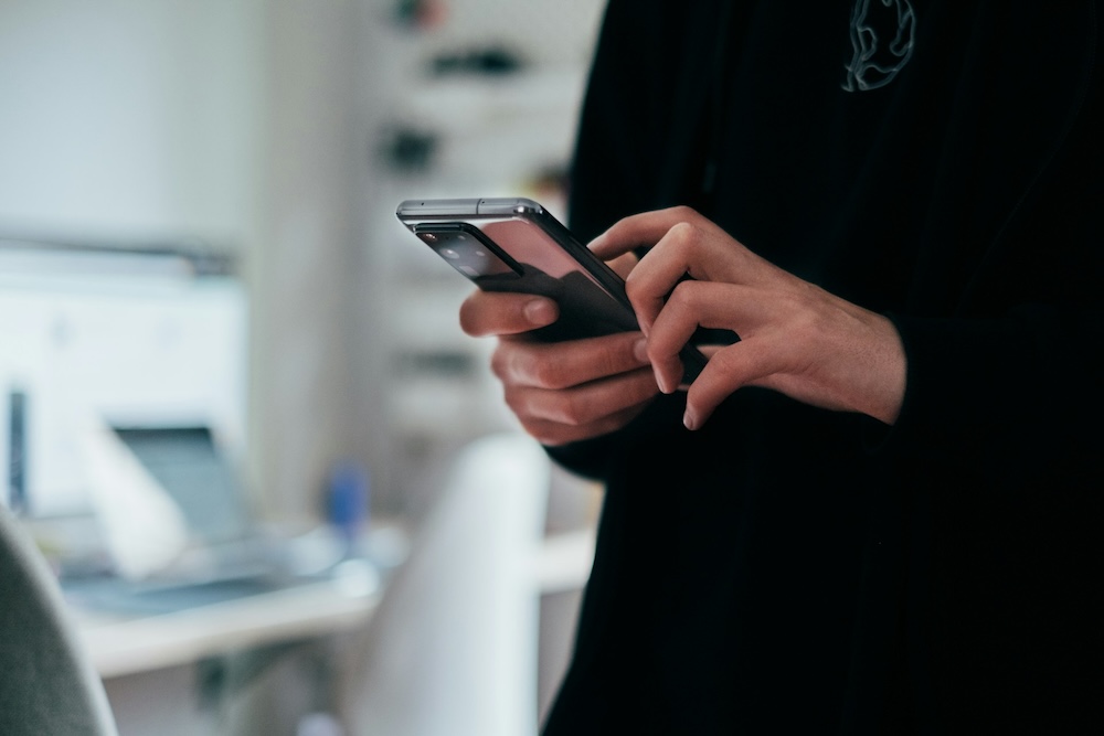 young man holding smartphone